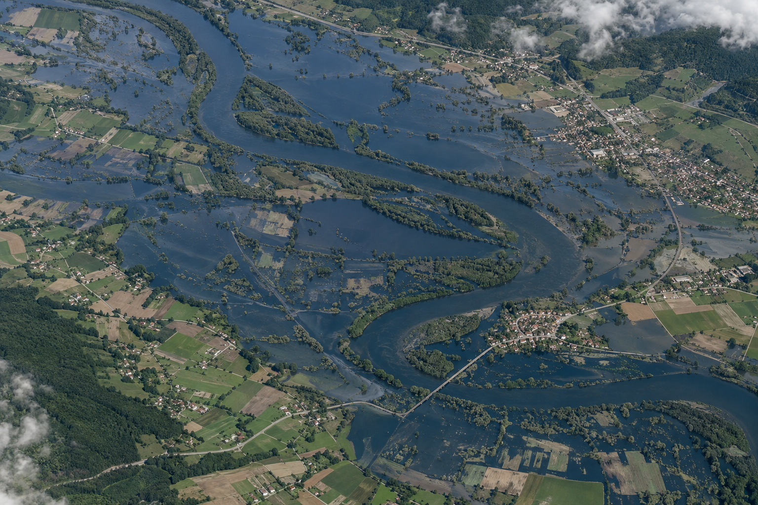 Earth-observation view of floodwater across a river floodplain